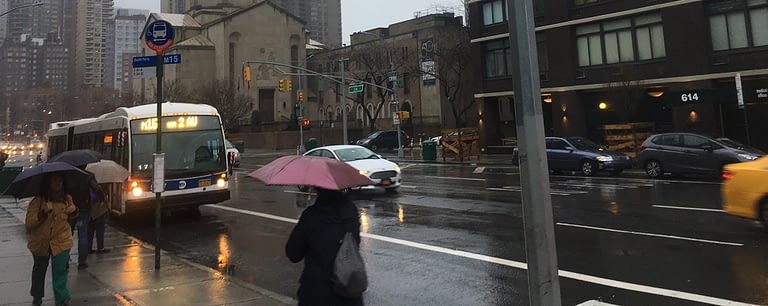 Photo of pedestrians with umbrellas
