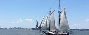 Photo of ship near Statue of Liberty