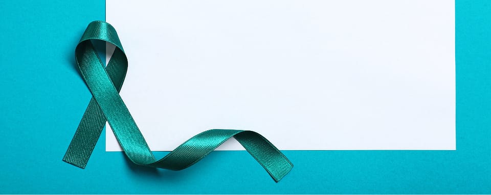Photo of blank sheet of paper next to teal ribbon